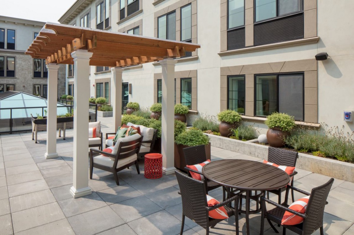Modern patio area with comfortable seating and a pergola.
