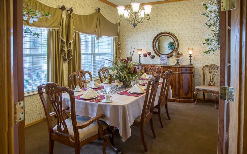 A beautifully arranged dining room with an elegant table setting.