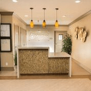 A modern reception area with stylish lighting and a sleek desk.