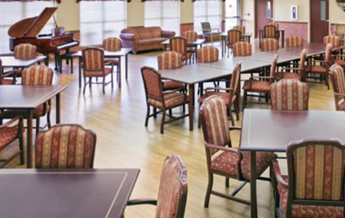 A spacious dining area with multiple tables and chairs arranged neatly.