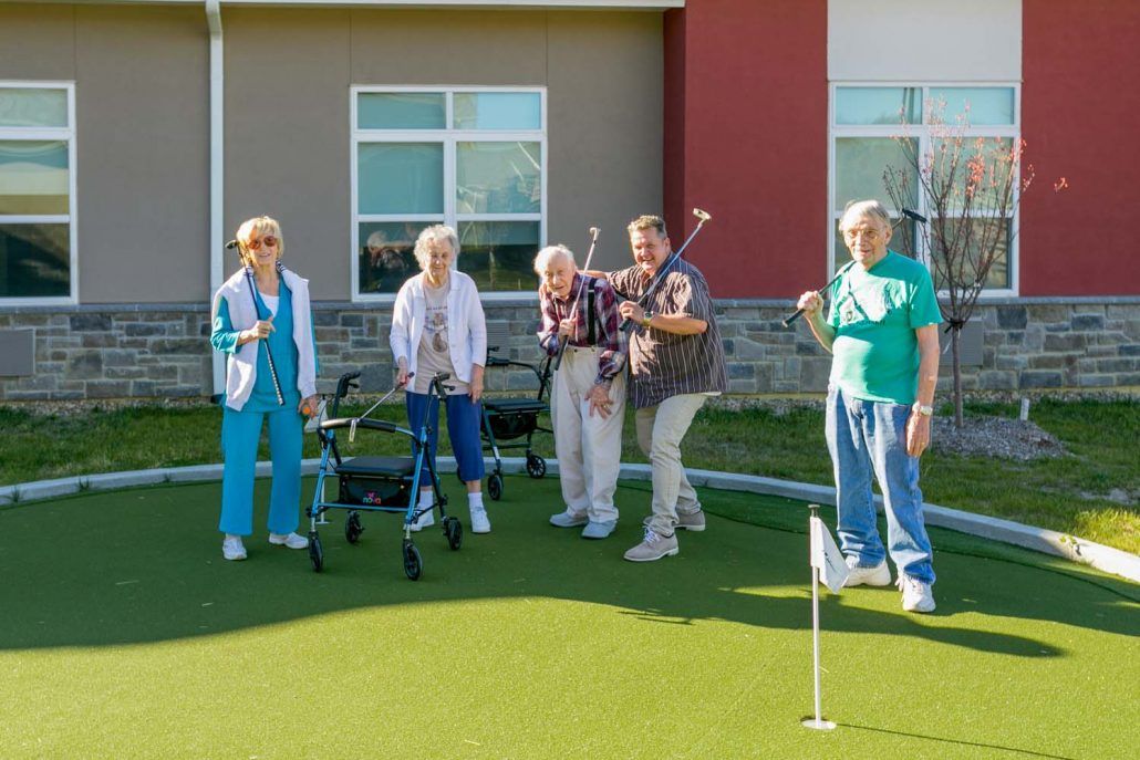A group of seniors enjoying a game of golf on a sunny day.