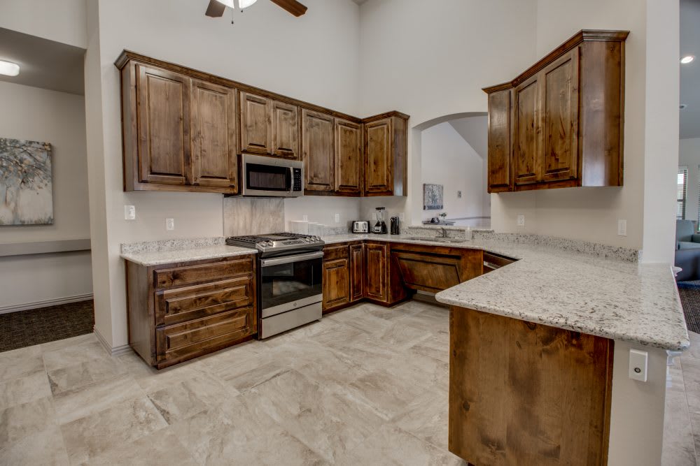 A modern kitchen with wooden cabinets and stainless steel appliances.