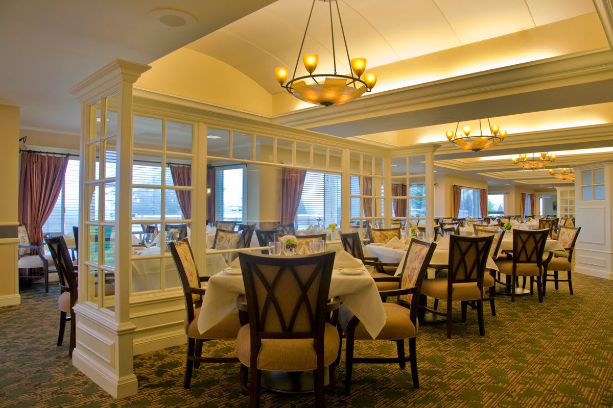 An elegant restaurant dining area with neatly arranged tables and chairs.