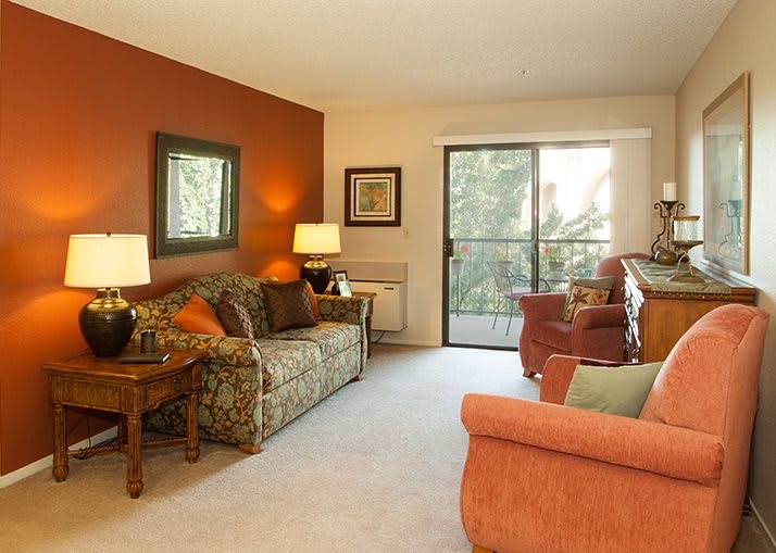 A cozy living room with comfortable seating and warm lighting.