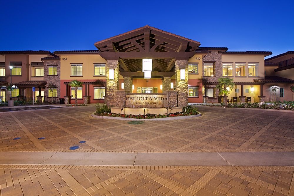 A modern building with illuminated lights at night, featuring an open courtyard.