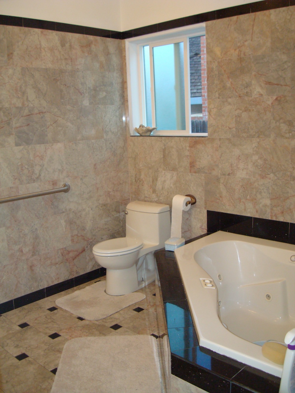 A modern bathroom with tiled walls and a bathtub.