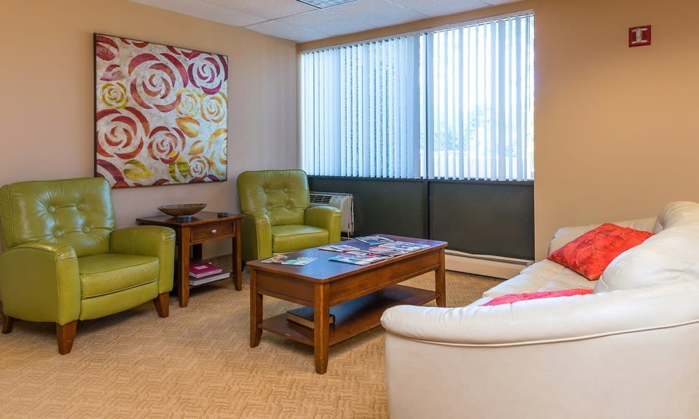 A cozy waiting room with comfortable seating and colorful artwork.