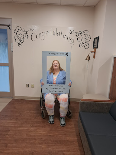 A joyous moment captured as someone celebrates a significant achievement in a wheelchair.