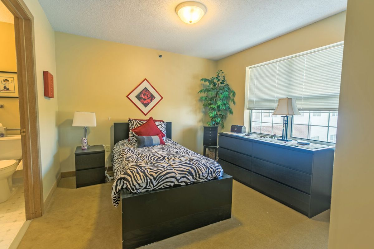A cozy bedroom with a single bed and modern furnishings.