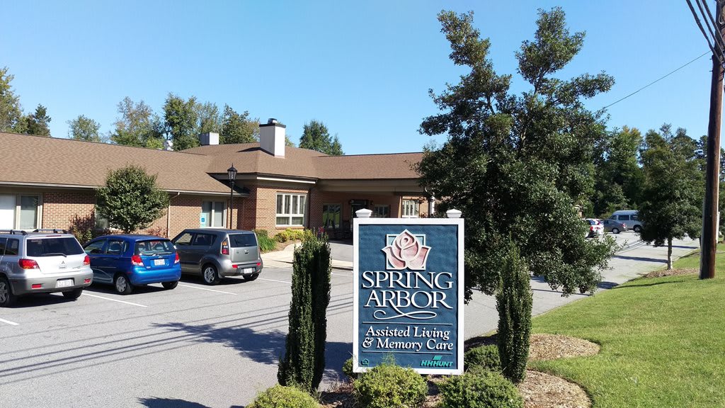 Entrance view of Spring Arbor Assisted Living & Memory Care with visible signage and surrounding landscaping.