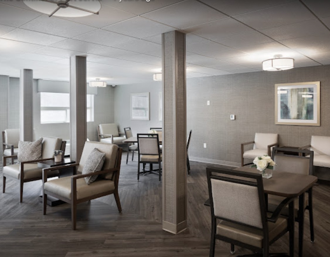 A modern interior space with comfortable seating and tables.