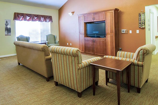 A cozy living room with comfortable seating and a large TV.