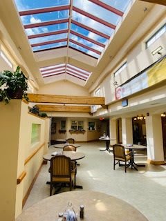 A well-lit interior dining area with skylights and modern furniture.