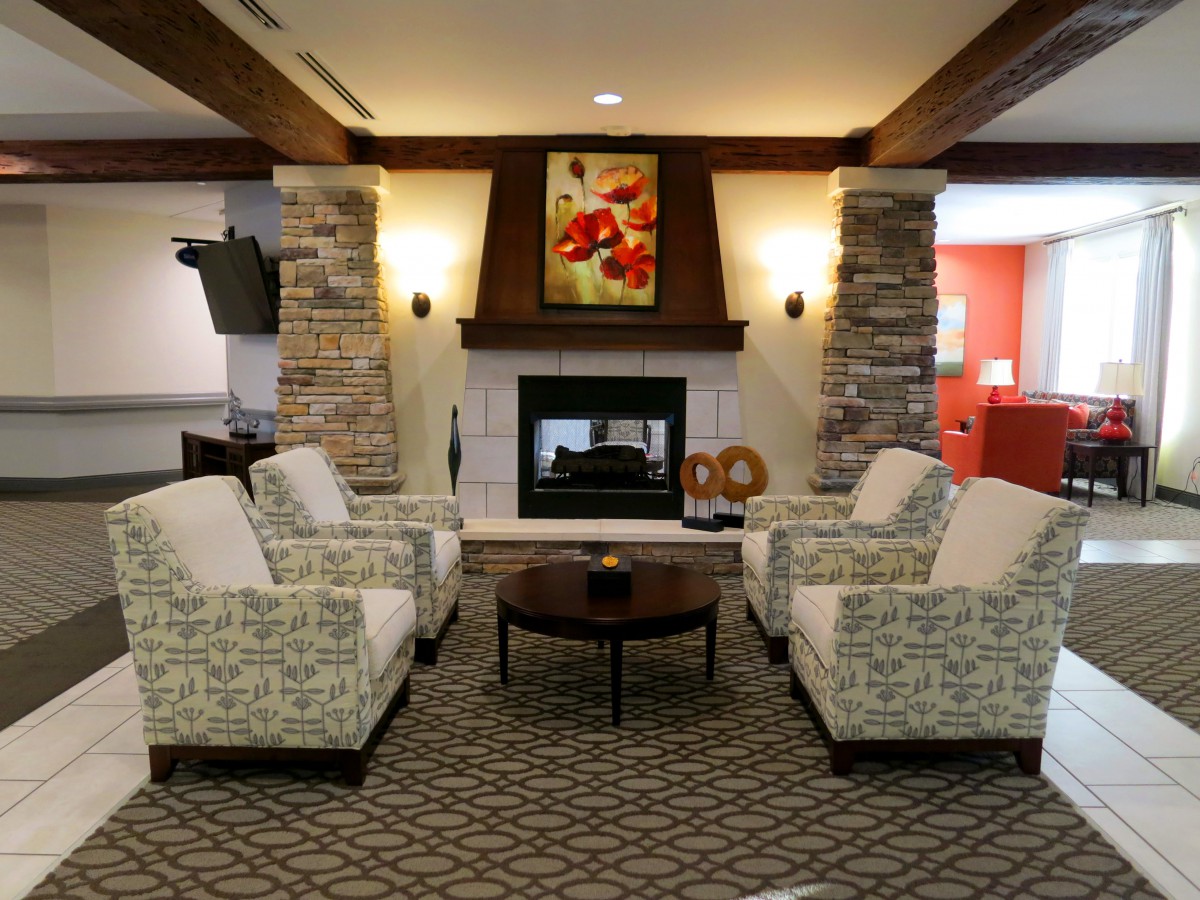A cozy living room with a fireplace and comfortable seating arrangement.
