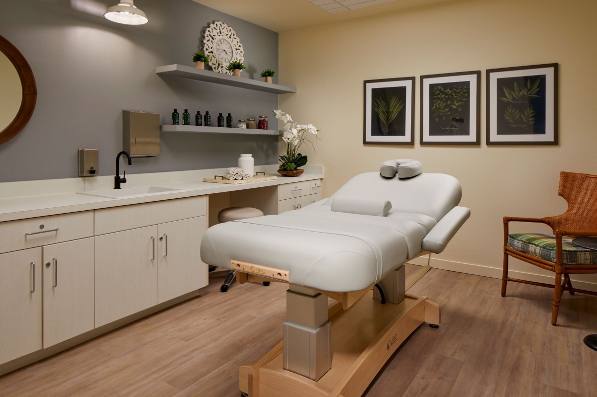 A tranquil spa room featuring a massage table and soothing decor.
