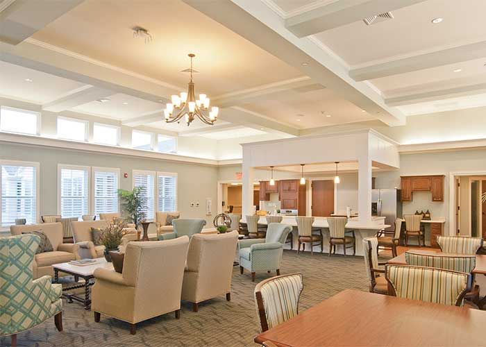 A spacious and elegantly decorated living room with comfortable seating and warm lighting.