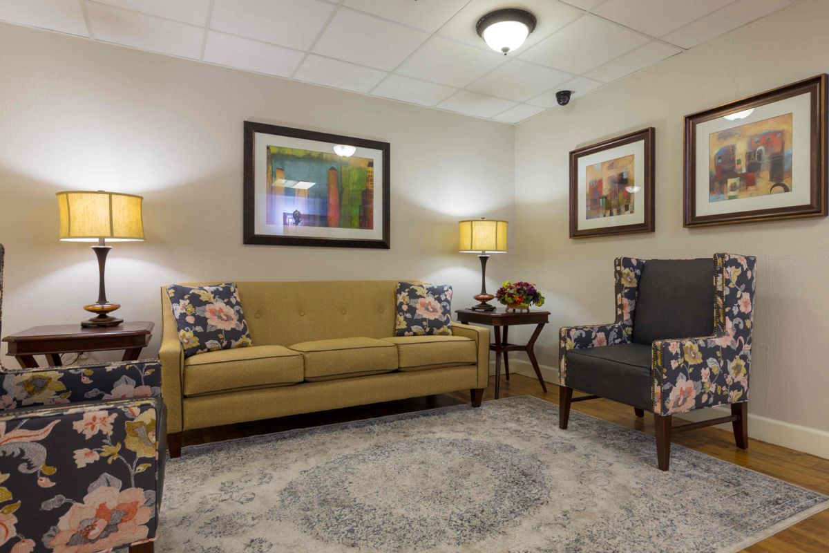 A cozy living room with a sofa, armchairs, and decor.