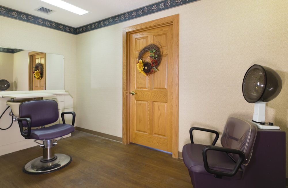 An empty waiting room with simple decor and seating.