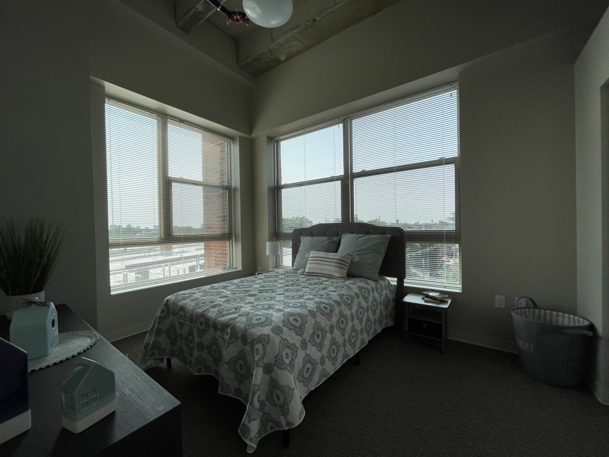 A modern bedroom with large windows allowing ample natural light.