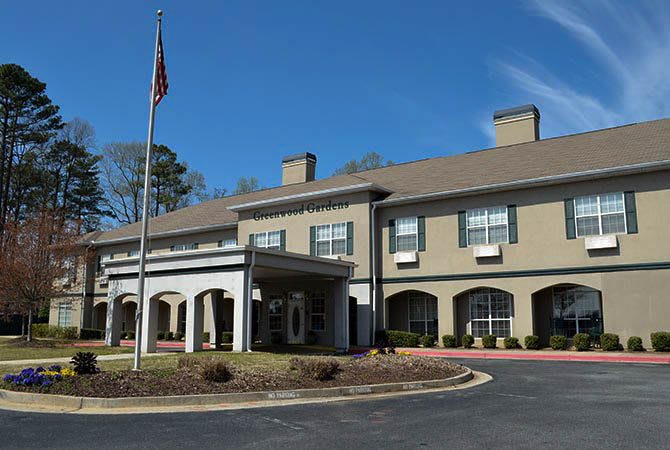 Exterior view of a hotel building with an American flag.
