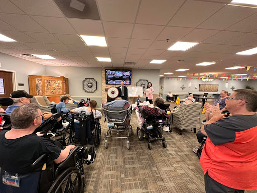 Residents of an assisted living facility gather for an activity in a communal area.