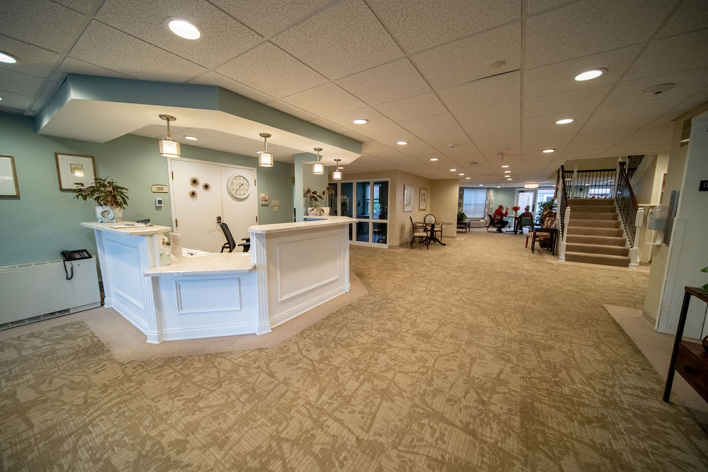 A spacious and modern lobby with a reception desk and seating area.