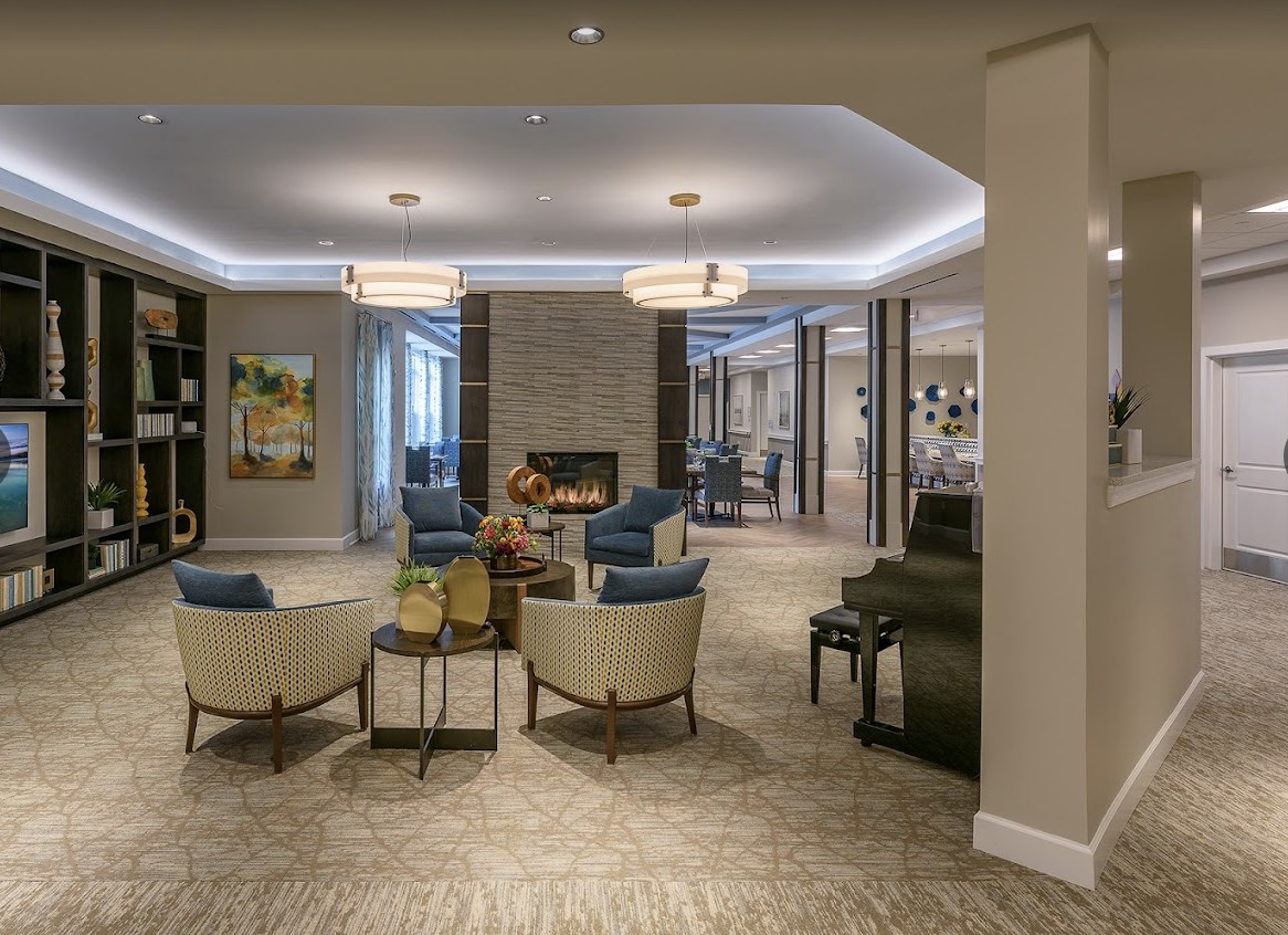 A modern lobby with comfortable seating and a fireplace.