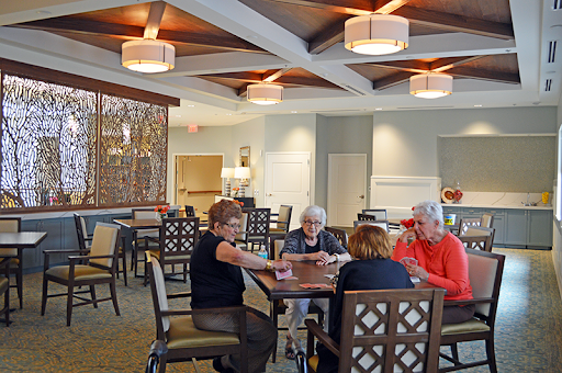 Seniors enjoying a game together in a cozy community center.