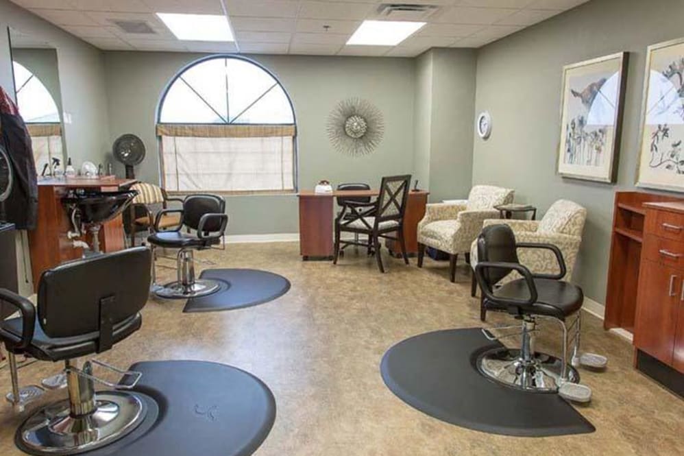 An interior view of a hair salon with styling chairs and a waiting area.