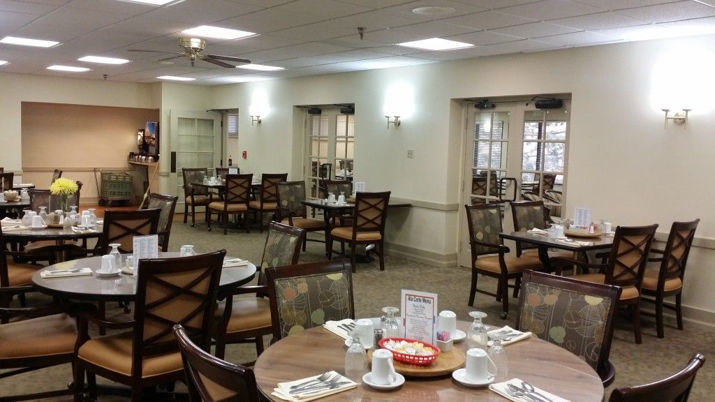 An indoor dining area with arranged tables and chairs, ready for guests.