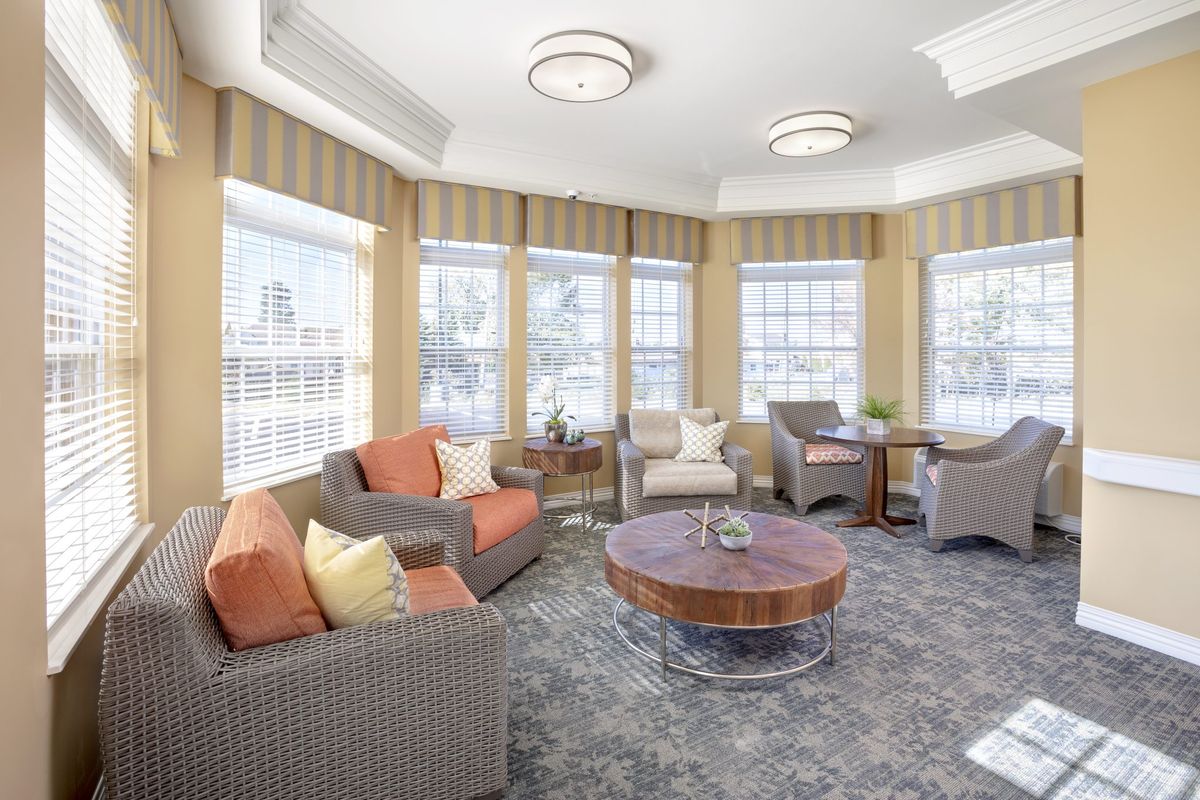 A bright and spacious living room with comfortable seating and large windows.
