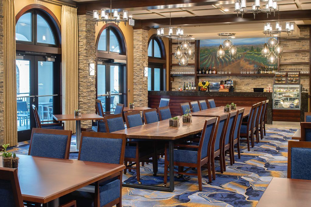 A well-lit conference room with tables and chairs arranged for a meeting.