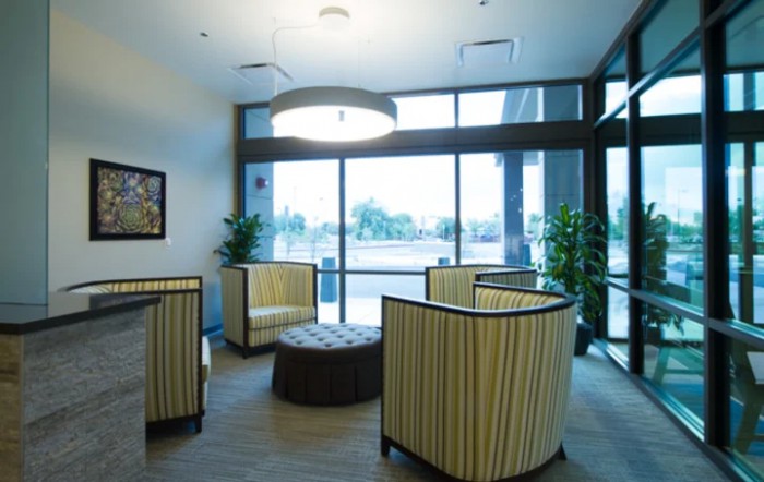 A modern waiting area with comfortable seating and large windows.
