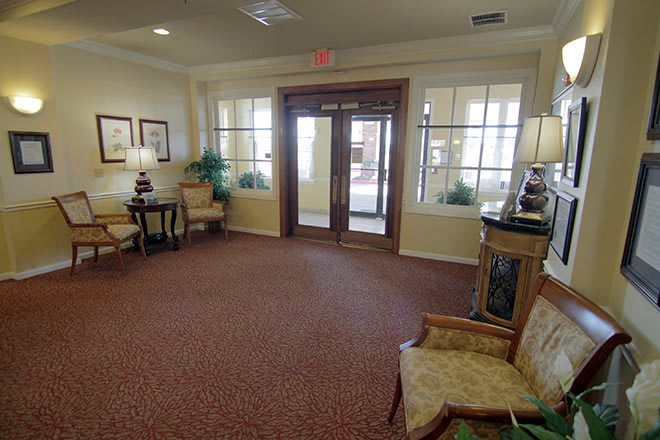 A cozy and well-furnished lobby with seating arrangements and decorative elements.