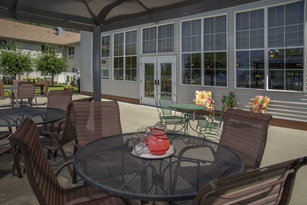 A cozy outdoor patio with seating and decor, perfect for relaxation.