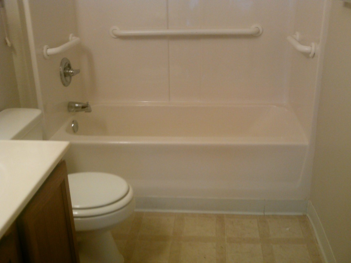 A bathroom with a bathtub and toilet.