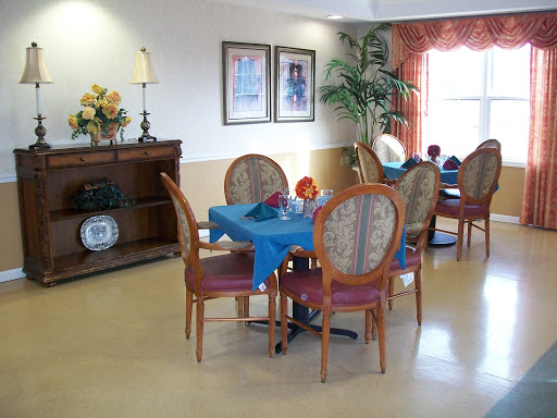 A cozy dining area featuring wooden furniture with a simple and inviting decor.