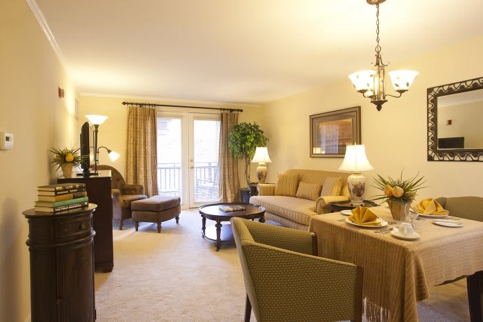A cozy and elegantly decorated living room with a comfortable sofa, warm lighting, and stylish furnishings.