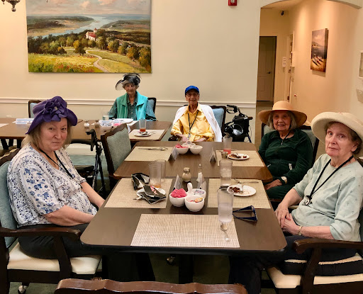 A lively group of senior citizens enjoying a meal together, showcasing camaraderie and community.