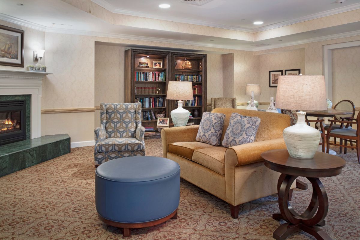 A cozy living room with comfortable seating and a well-stocked bookshelf.