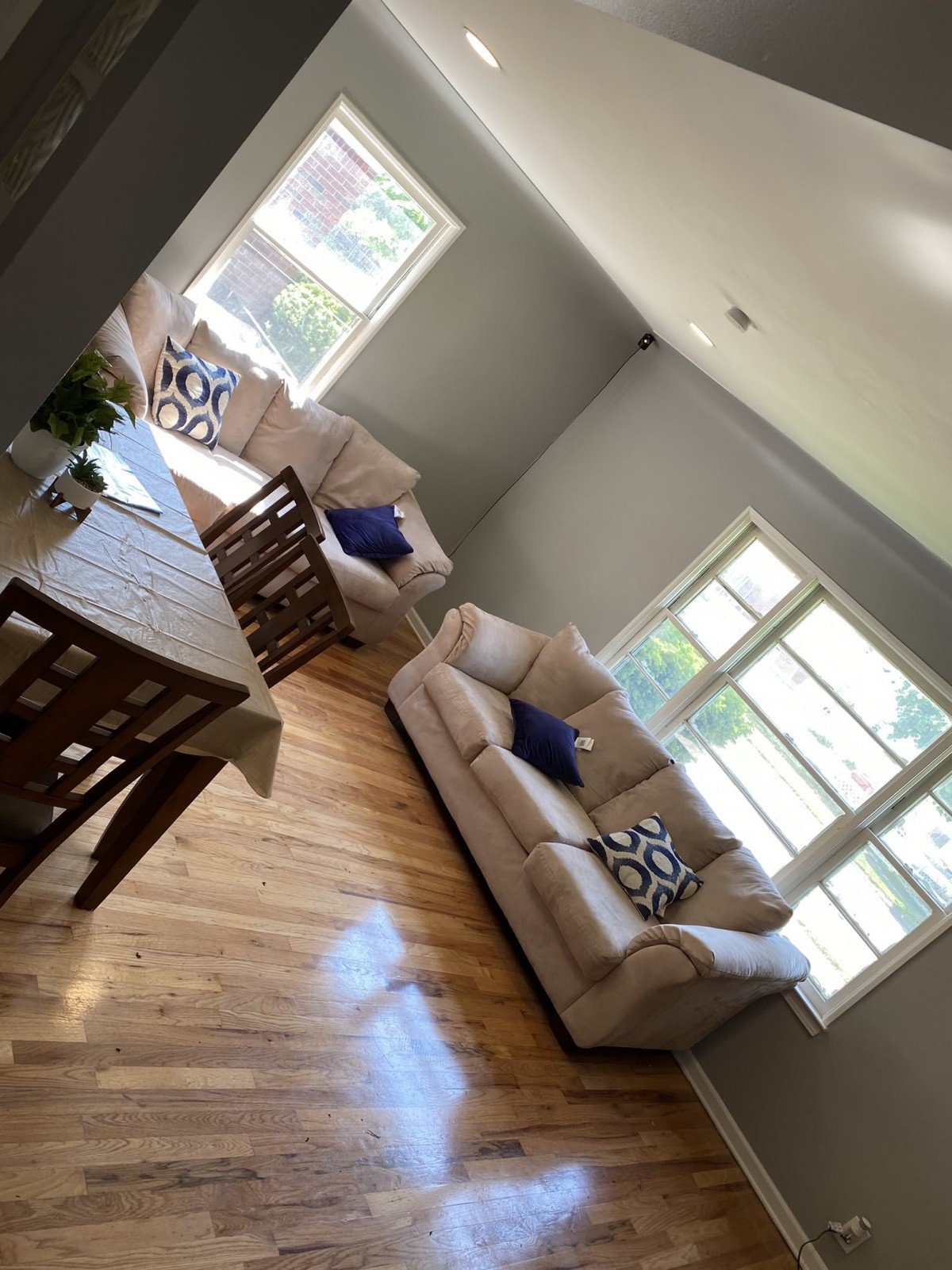 A bright and airy living room with comfortable sofas and a dining table.