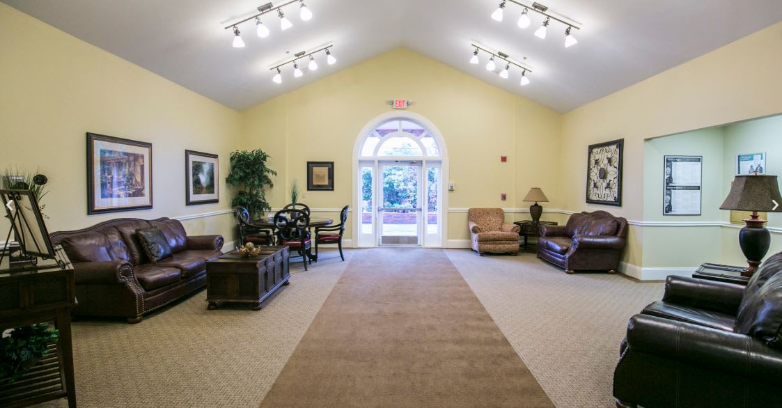 A well-lit lobby area with comfortable seating and decor.