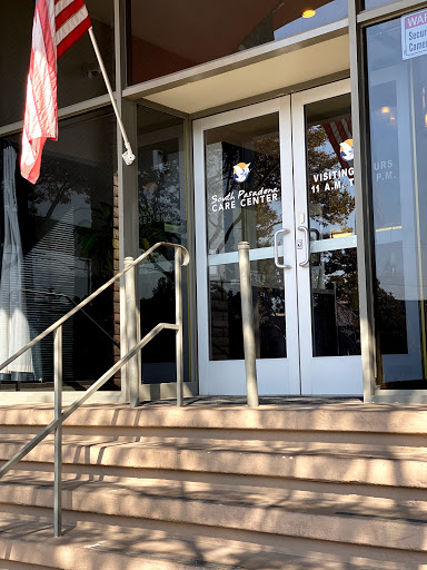 Entrance of a building with stairs and glass doors.