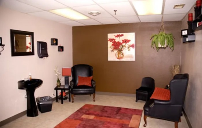 A cozy waiting room with comfortable seating and warm decor.