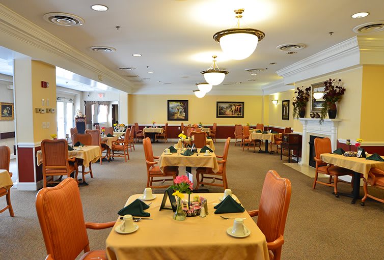 An elegant dining room with neatly arranged tables and chairs.