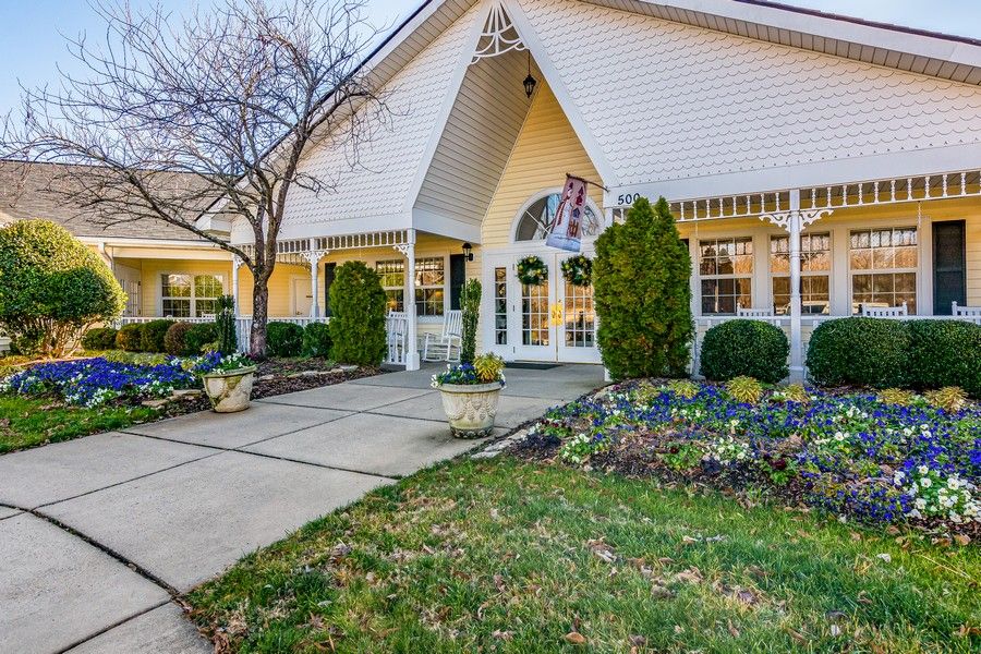 A residential building with landscaped gardens and a welcoming entrance.