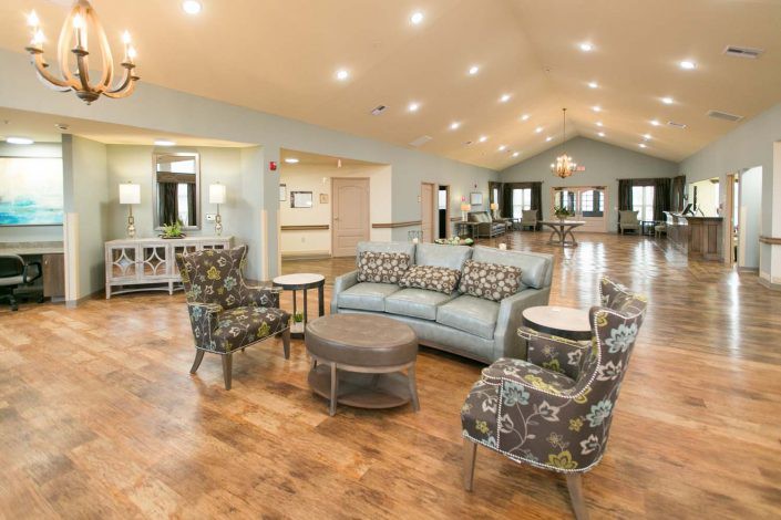 A spacious living room with stylish furniture and elegant lighting.