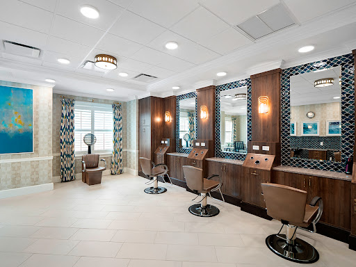 A modern hair salon featuring stylish barber chairs, well-lit mirrors, and contemporary decor.