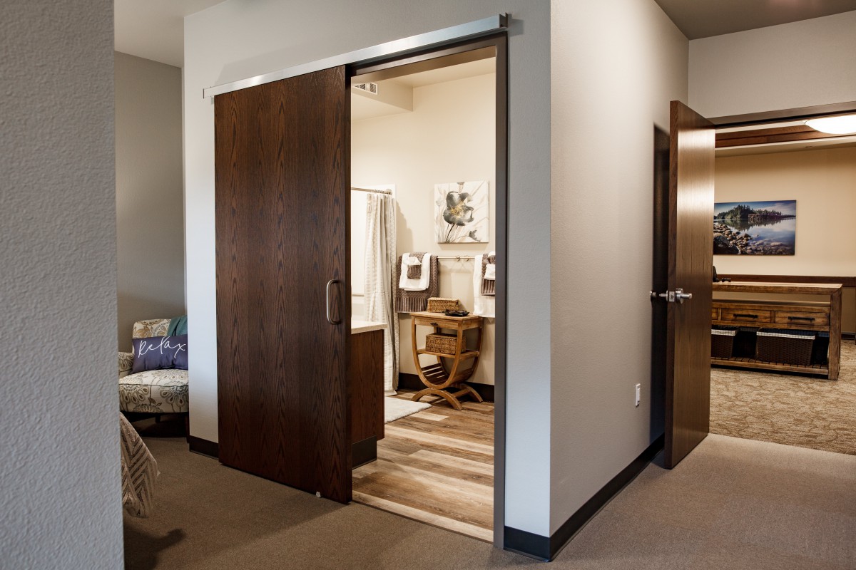 A home office with a sliding door partially open, revealing a cozy workspace.