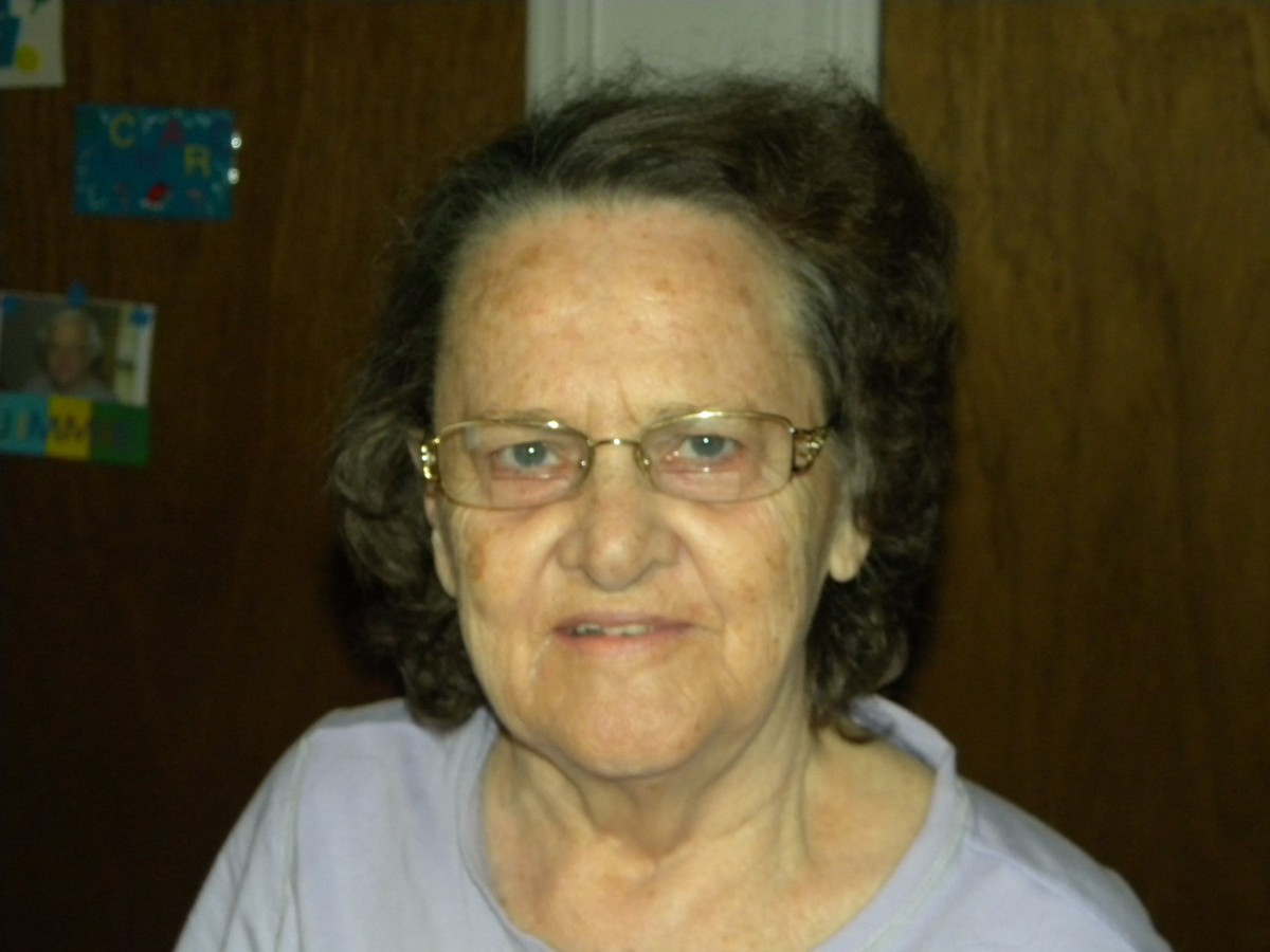 Portrait of an elderly woman wearing glasses.
